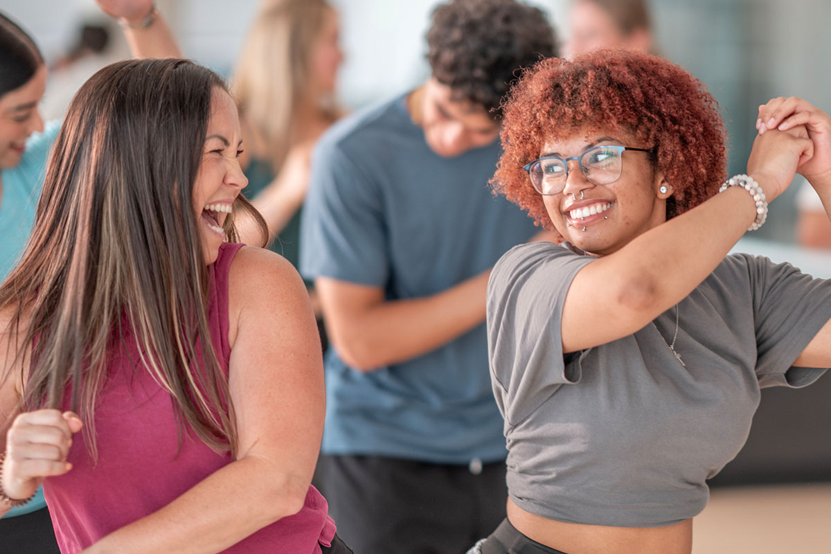 two adult women dancing